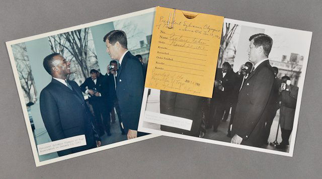 1962-Mar 20, J.F.K., w/ Pres. Olympio of Togo: (1) Color photograph of J.F.K. with President Sylvanus Olympio of Togo on Mar 20, 8" x 10", taken by R. Knudsen. Together with a black and white example, 8" x 10" with negative. Condition: Toning Note