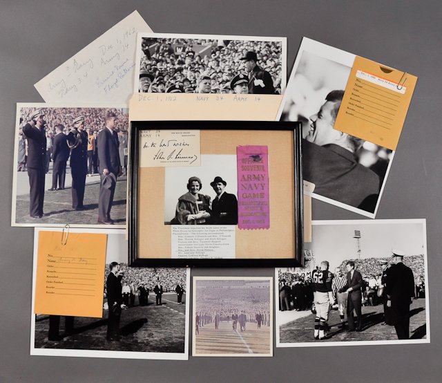 1962-Dec 1, Army Navy Football Game: (1) Framed memento of the Powers at the game with photograph, account of the day, the score on J.F.K. (facsimile signed) calling card and a souvenir ribbon. (1) Color photograph of J.F.K. at attention