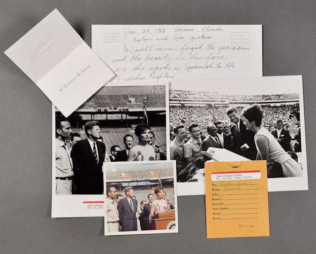 1962-Dec 29, Jackie Wows Freedom Fighters: (1) Color photograph of Jackie speaking Spanish to the Cuban Freedom Fighters on Dec 29 in Miami. 5" x 5". Together with (1) Black and White photograph and negative of the same image. (1) Photograph s
