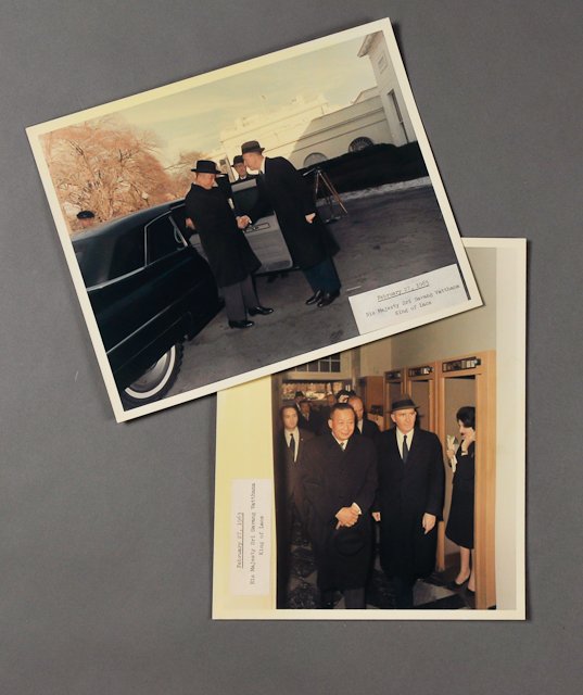 1963-Feb 27, J.F.K., King of Laos: (2) Color photographs of Dave Powers escorting H.M. Sri Savang Vatthana on Feb 27. 8" x 10". Fading, pressure sensitive adhesive labels. Each taken by Cecil Stoughton. Condition: See Description