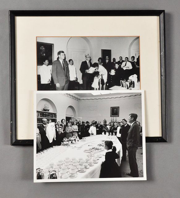 1963-April 25, David Powers', Birthday Party: (2) Photographs of David Powers with J.F.K and surrounded by guests at the White House April 25. 8" x 10" each. (1) Framed. Condition: Good
