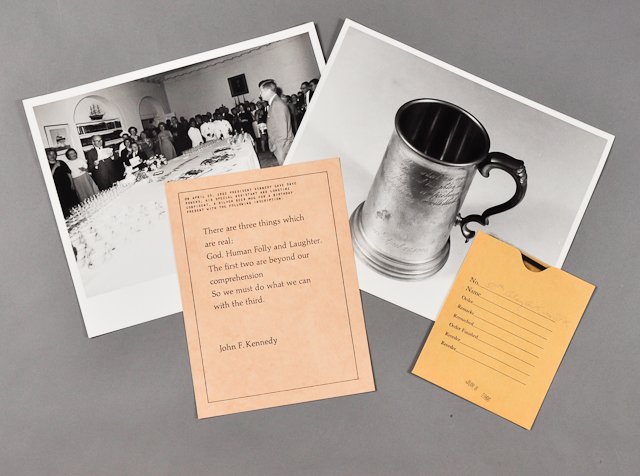 1963-April 25, J.F.K., Gifts to Dave Powers: (1) Photograph and negative of J.F.K. giving gifts to Dave. 8" x 10". (1) Card describing gift of a silver beer mug. (1) Photograph of the engraved mug. 8" x10". Condition: Good