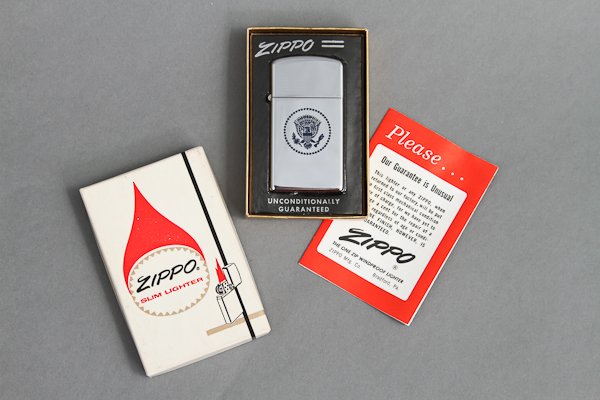 1963-June, Presidential Lighter: (1) Chrome Slim Zippo Lighter in its original box and engraved in blue with the Great Seal of the President recto and "European Trip of President Kennedy June 1963" verso. 2 1/4" Condition: Good, Orig