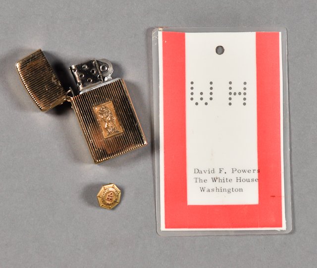 1963-July 2, J.F.K., Vatican City, Rome: (1) Gold-tone cigarette lighter with image of Joseph carrying Christ. Minor wear (1) Lapel Pin with Newman's Coat of Arms, "Heart Speaks to Heart". Good. (1) White House Security Pass belonging to Dav