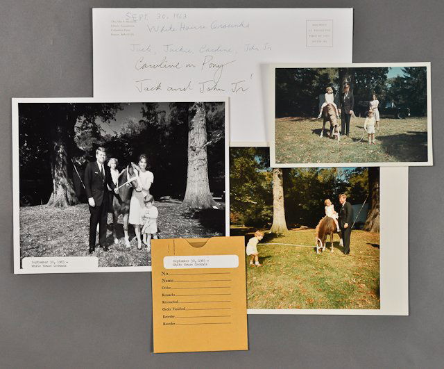 1963-Sept 30, Kennedy Family at White House: (1) Color photograph of the Kennedys on the White House Grounds. Sept 30. 4 1/2" x 7 1/2". (1) Color photograph of the Kennedys in a slightly different pose. 7 1/2" x 7 1/2". Good. (1) Photograph and