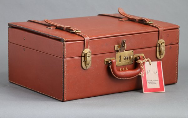 Briefcase with Lap-Desk Interior: (1) Leather brief case bearing the initials of Eunice Kennedy Shriver with David Powers White House pass tag attached. 18" x 13" x 8". minor wear. (1) Bronze presentation medal with portrait "Presiden