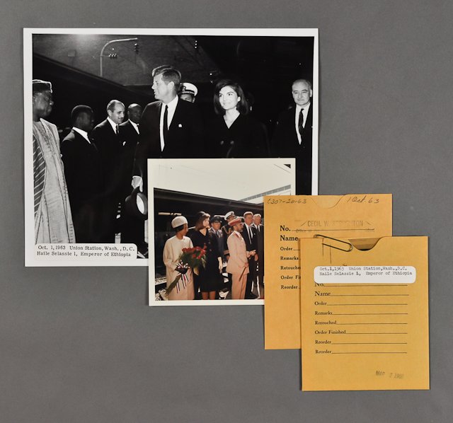 1963-Oct 1, J.F.K., Jackie Greet Dignitaries: (1) Color photograph, later reprint, of the Kennedys greeting dignitaries. 5" x 5". Taken by Cecil Stoughton. (1) Photograph and negative of J.F.K. and Jackie greeting Haile Selassie I the Emperor of 