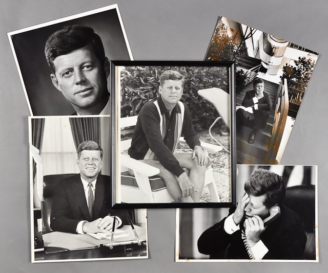 J.F.K. Photographs: (5) Large format photographs of J.F.K. (1) Formal portrait (1) on steps. Toning. Taken by P. Schutzer. (1) In Oval Office. Tear, stains. Taken by Arnold Sacks. (1) Poolside. Framed. (1) On telephone. 