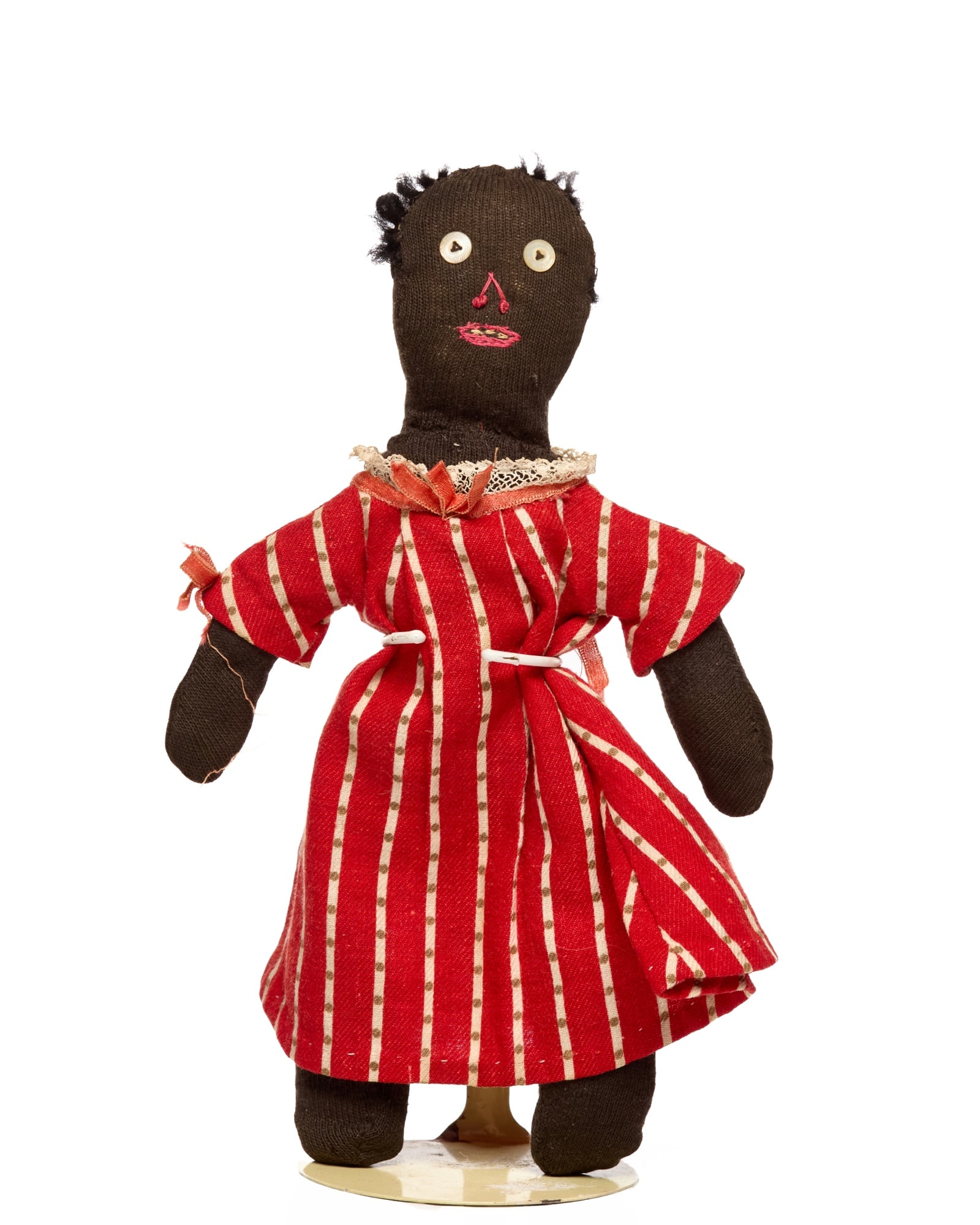 TINY 9 INCH BLACK STOCKINETTE DOLL CIRCA 1920: Tiny, cute, old, 9 inch circa 1920 black stockinette doll. Little black stockinette doll with button eyes and embroidered nose and mouth. Her mouth is again the straight line across, (what I call a ne