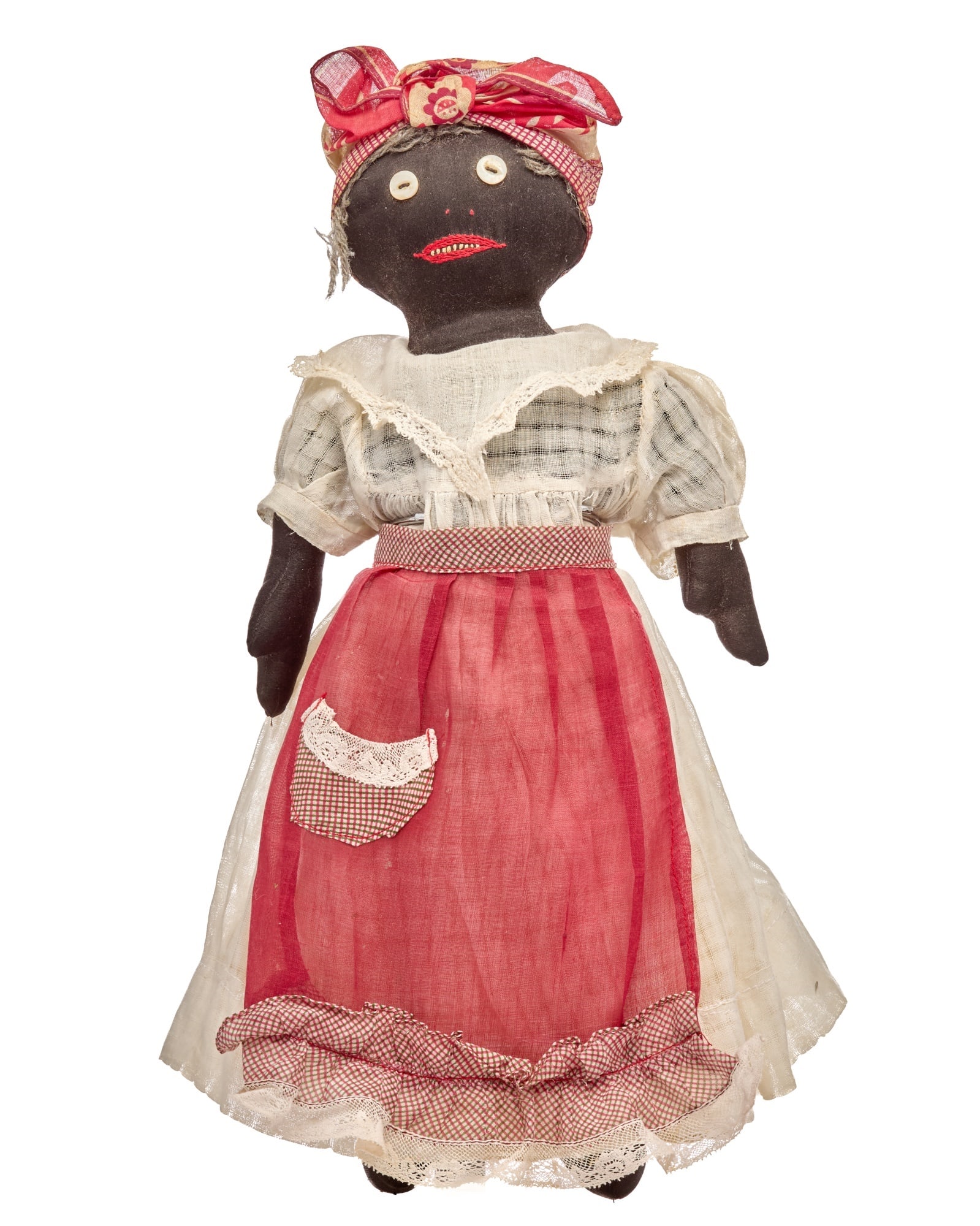 15 IN BEEN A BUSY DAY, BLACK CLOTH DOLL: Black cloth doll, with button eyes, dots for her nose and red floss embroidered mouth and 9 white stitched teeth. Her gray yarn hair is mostly covered by a red bandana kerchief. Over her cotton stuffe