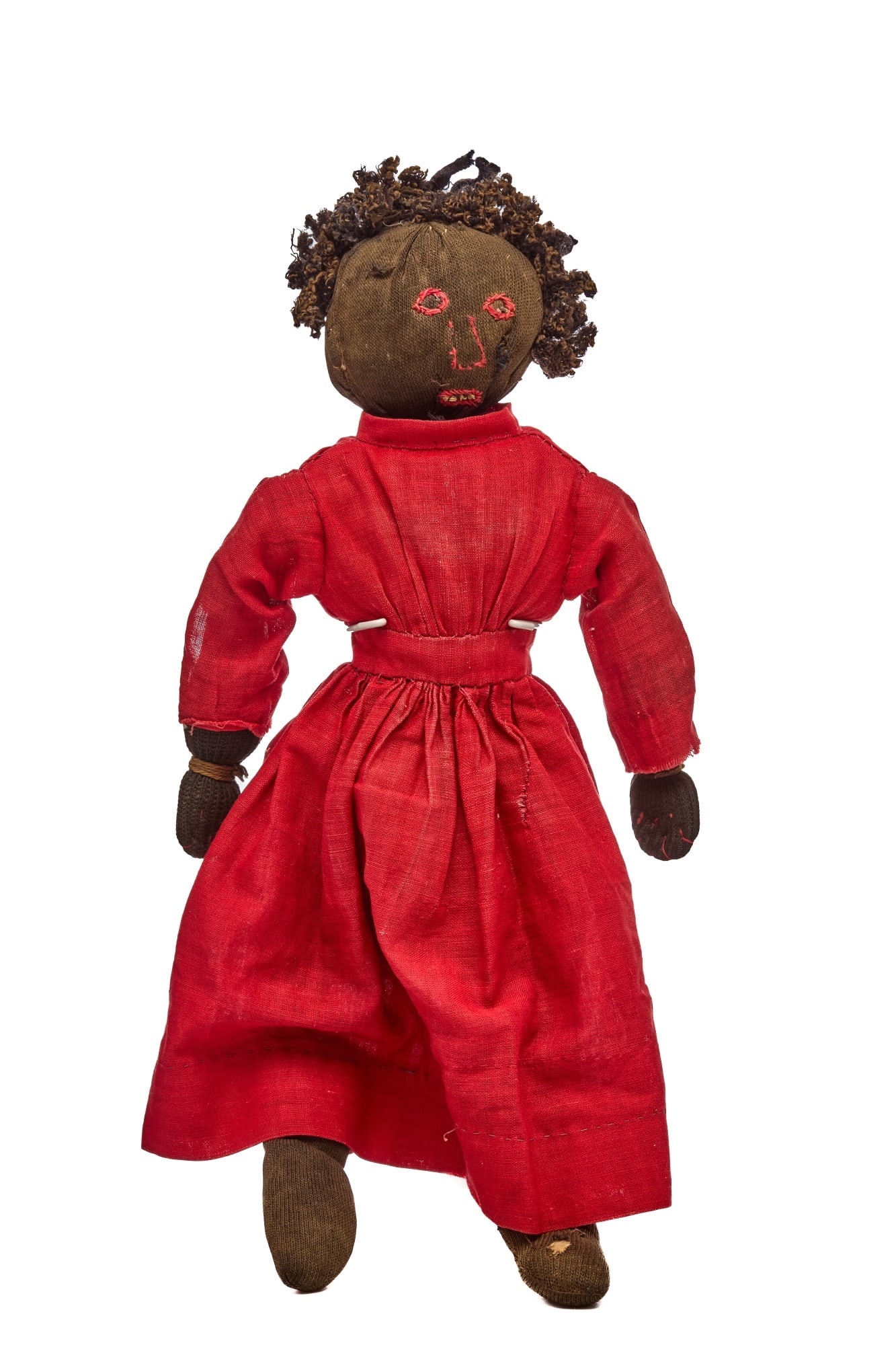 14 IN ROUND HEAD WILD HAIR BLACK DOLL: This stockinette black doll, a dear soul, has red embroidered eyes, nose and mouth, with a few white teeth. Her body is softly stuffed with cotton. Her red dress is hand sewn and fits her nicely. Her 