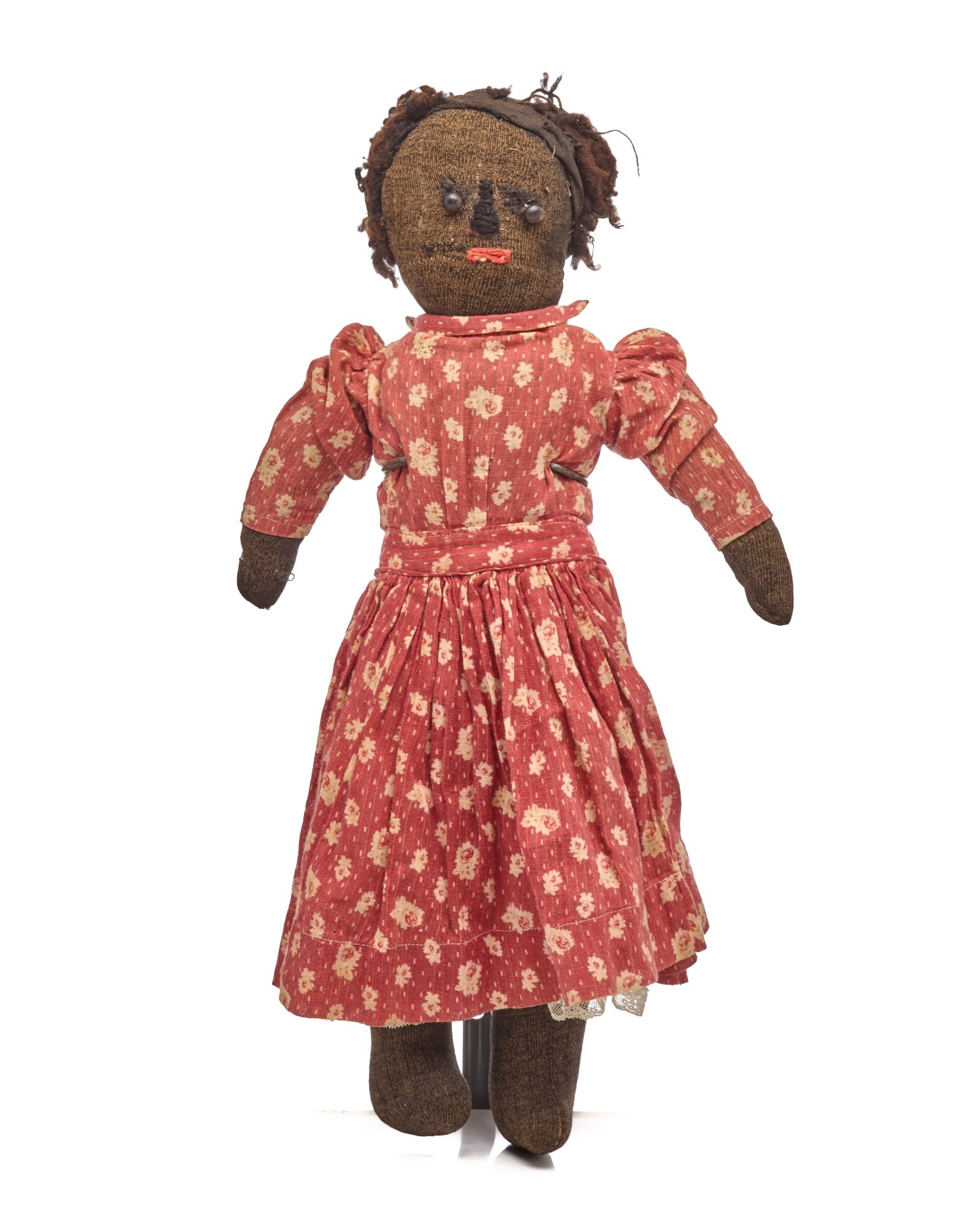 17 IN STOCKINGNETTE BLACK DOLL: 17 inch stockinette black doll with button eyes and embroidered nose and red floss lines with a couple of white dots for teeth underneath the red floss. She has wool hair, she is firmly stuffed with c