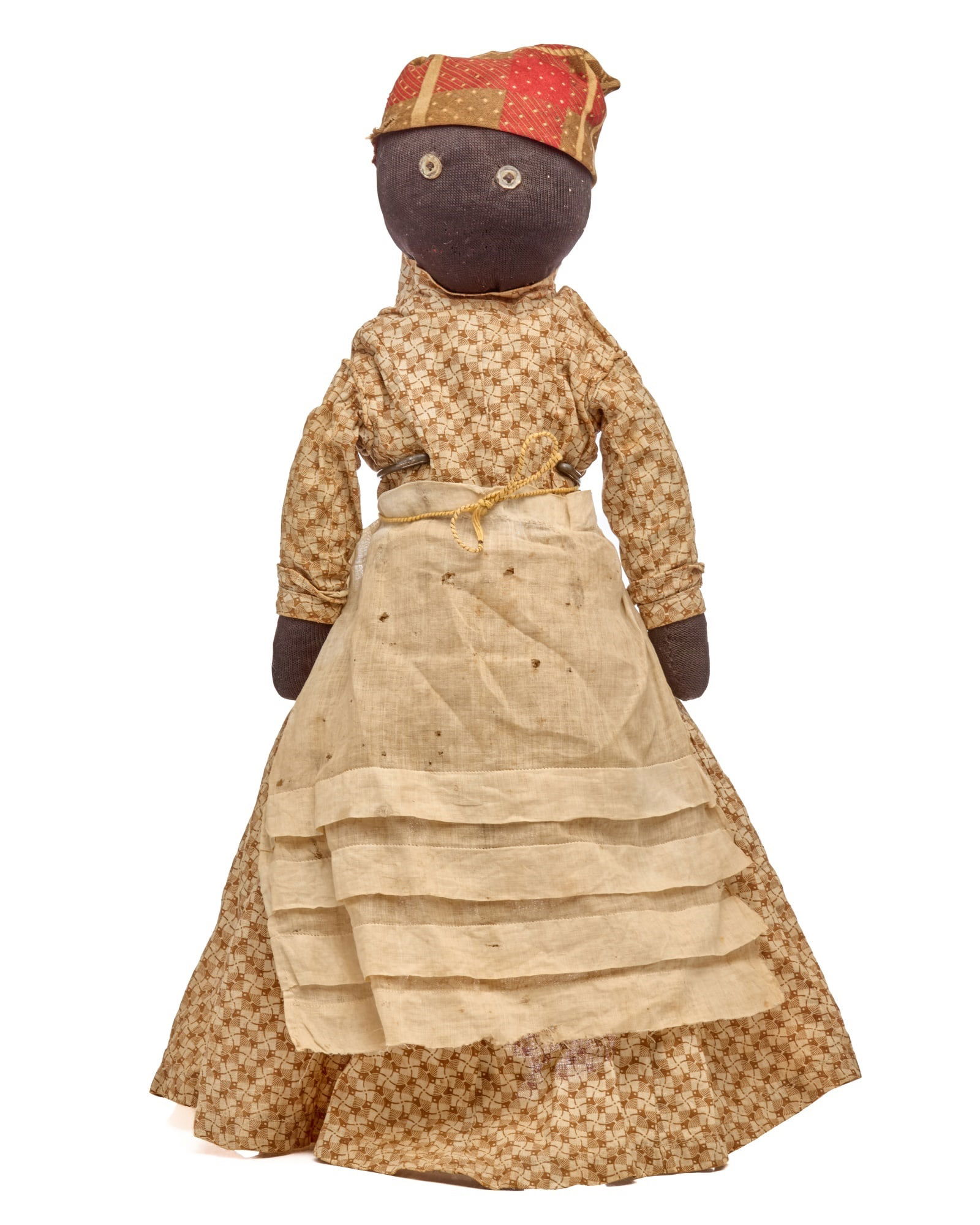 12 IN STUMP DOLL WITH NICE HEAD SCARF: Round head, button eyes, old head scarf, and brown calico dress, make this 12” stump doll a very nice black cloth doll. She has what feels like stiff paper that goes up her back and holds her he