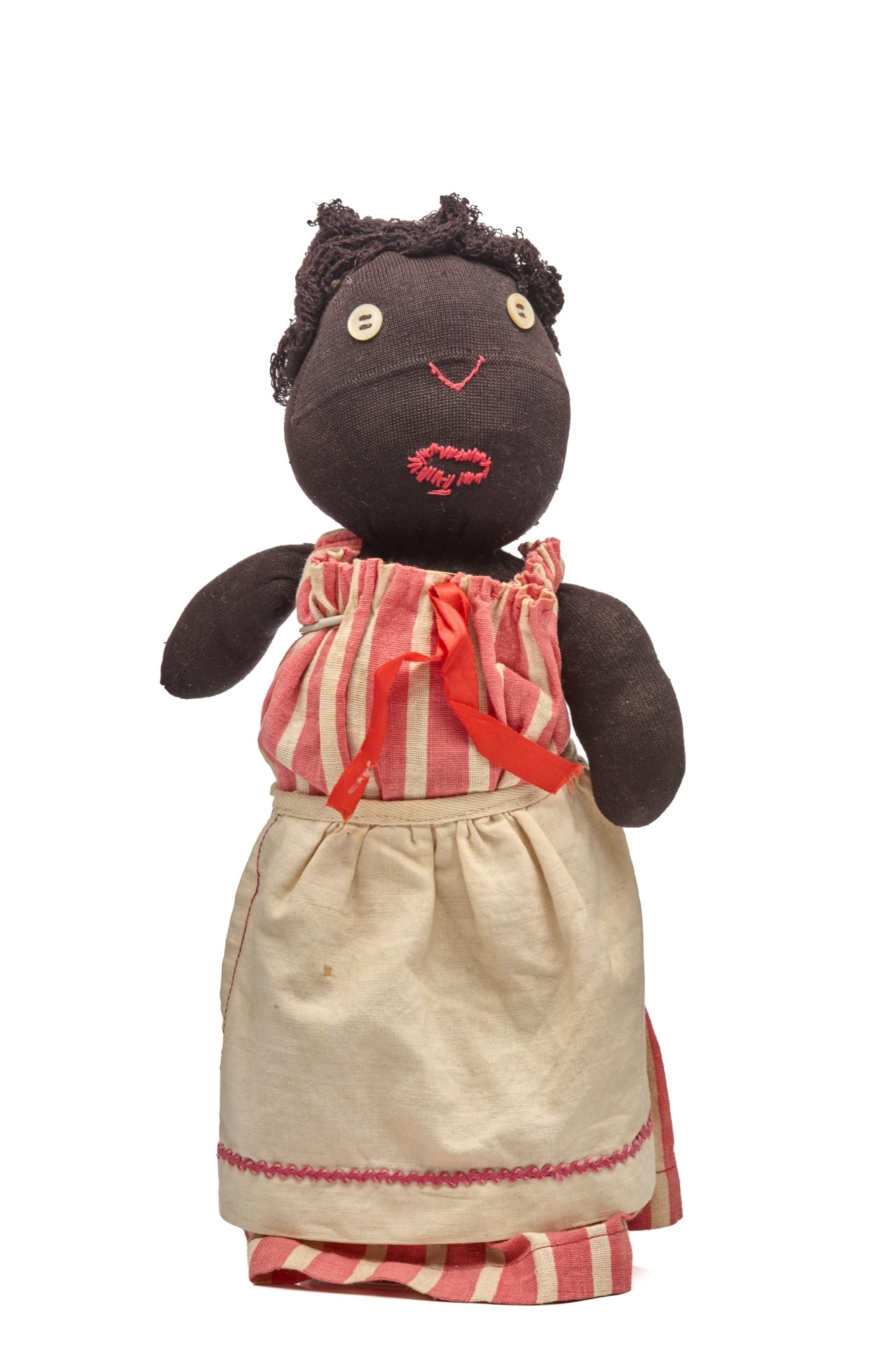 12 INCH BLACK STOCKINETTE DOLL in CANDYSTRIPE: Little stocking doll with simple homemade dress all original. Little button eyed, embroidered nose and mouth, black doll. She has great early finely woven string hair. Her dress couldn't be any simple