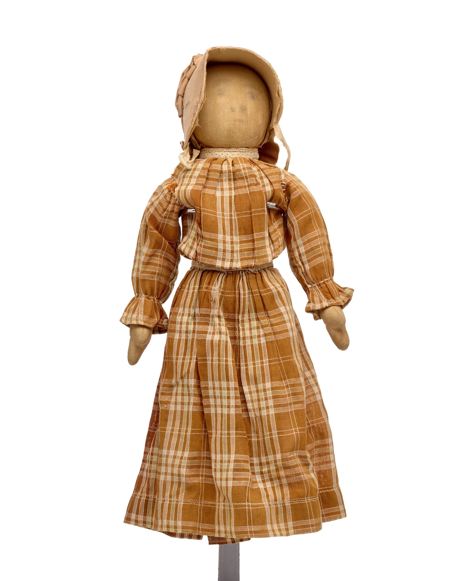 14 IN PRAIRIE BONNET DOLL: This small little country doll with a drawn pencil face is, pretty as a picture. She has a firmly stuffed body, mitten hands, small feet. She is hand sewn, wearing an antique brown plaid dress with la