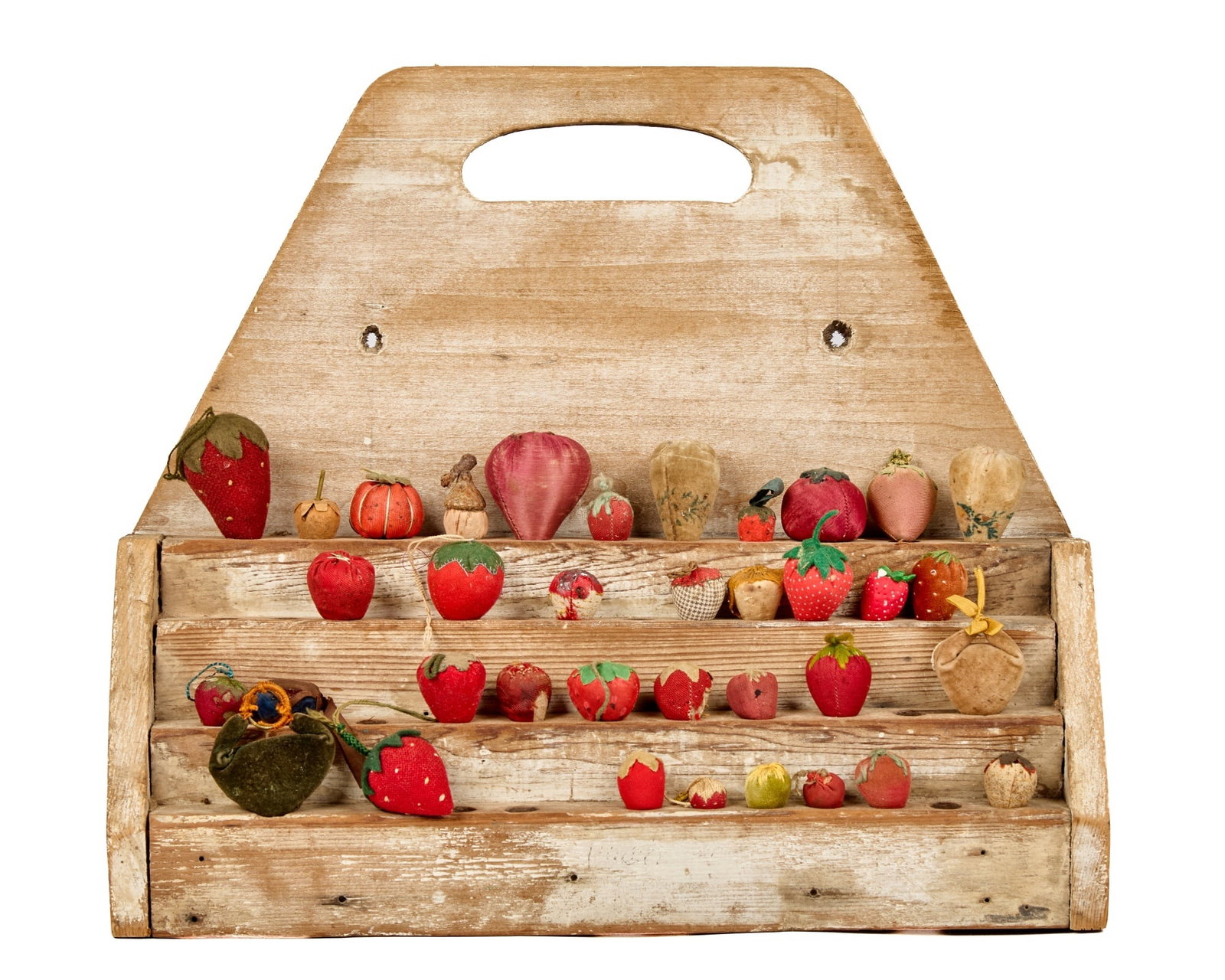 16 1/4 IN. EARLY SHELF WITH COLLECTION OF STRAWBER: This early stepped shelf in original old white paint has multiple holes. I don’t know what the intended use was, but it works well holding a collection of old and antique strawberry emeries. It 