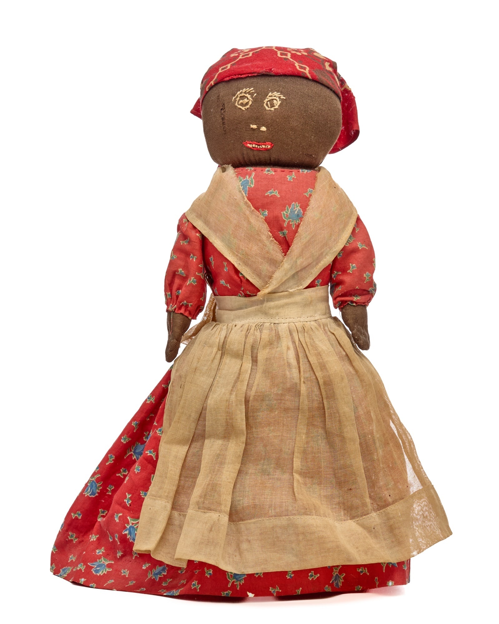 13 IN RED DRESS EMBROIDERED FACE: This bottle doll has a very nice, embroidered face, her mouth has teeth, her eyes have eyelashes, her dress is a pretty red and blue print with an apron over it. Condition: The dolls clothes have some