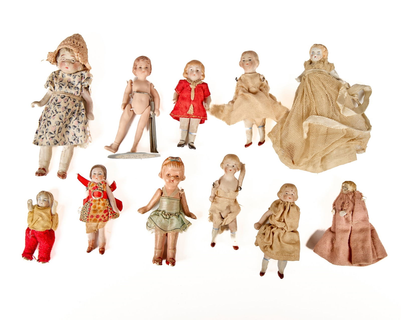 (11) BISQUE DOLLS.: This lot is a little bit of everything. They are all bisque, and range in size, from the shortest, 2 in. and the tallest 4 ¼ in. circa. 1900-1930 Condition: Condition, they are all a little worn
