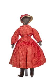 18 IN BLACK CLOTH DOLL RED POKADOT DRESS: 18 Inch black cloth doll with a blank face, firmly stuffed cotton body, arms ending with point, nicely shaped feet. Wearing a red polka dot dress and petticoat and bloomers with matching trim. Circa 1