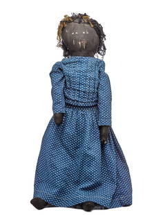 26 IN BLACK CLOTH DOLL PAINTED FACE: 26 Inch black cloth doll painted face wearing a blue calico dress and a pair of pantaloons. Made with black sateen fabric. Fairly firmly stuffed with cotton. Jointed at shoulders, elbows, hips and kne