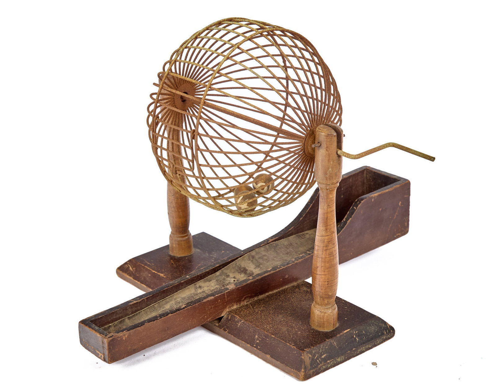 ANTIQUE SPINNING LOTTERY GLOBE CAGE: Spinning iron wire globe cage on wooden stand, with (3) wooden balls. 12 x 13 x 18 1/2 inches. Condition: Corrosion/paint loss to cage. Temp No 2213