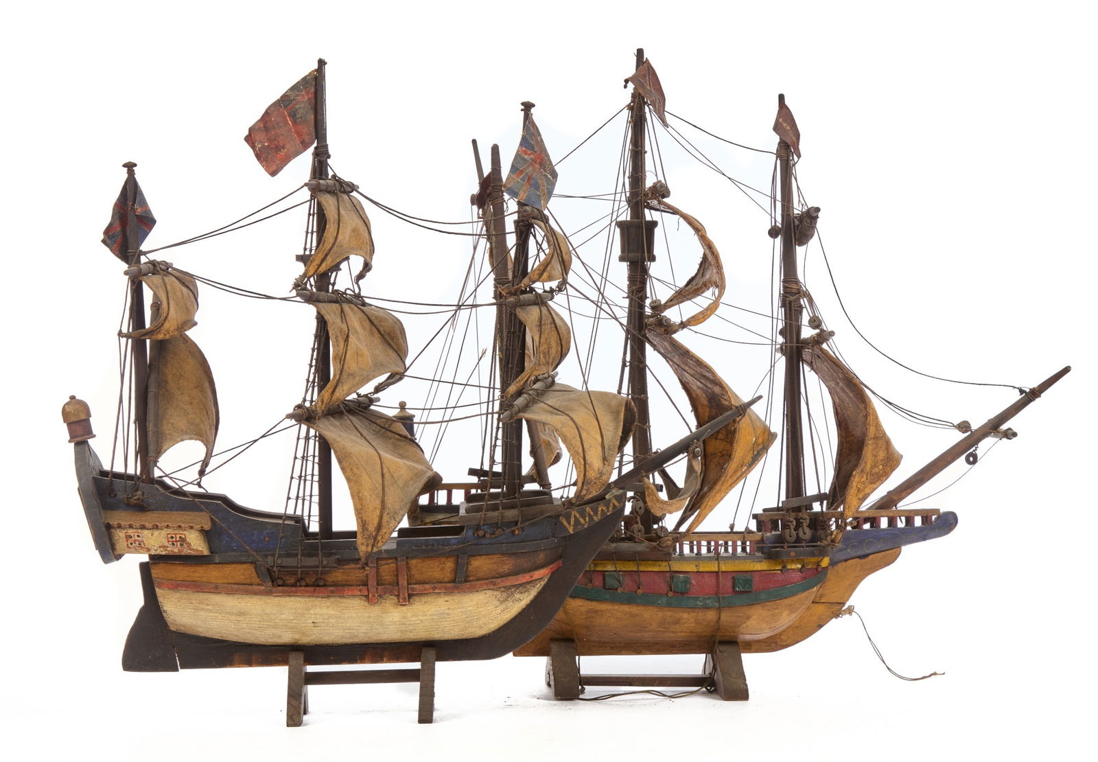 (2) (20th c) DECORATIVE HAND PAINTED SHIP MODELS: 19 1/2" long Condition: Surface grim, some rigging needs repair Temp No 2402