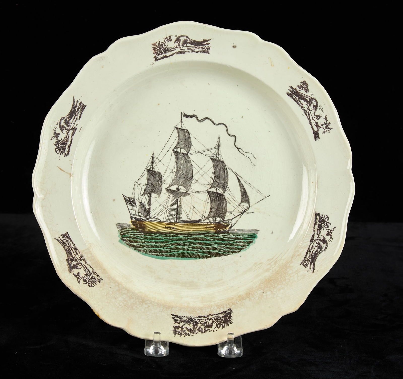 LIVERPOOL TRANSFERWARE PLATE circa 1800: Hand colored and depicting an unidentified British ship. 10 inches. Condition: Hairline, staining. Temp No 2827