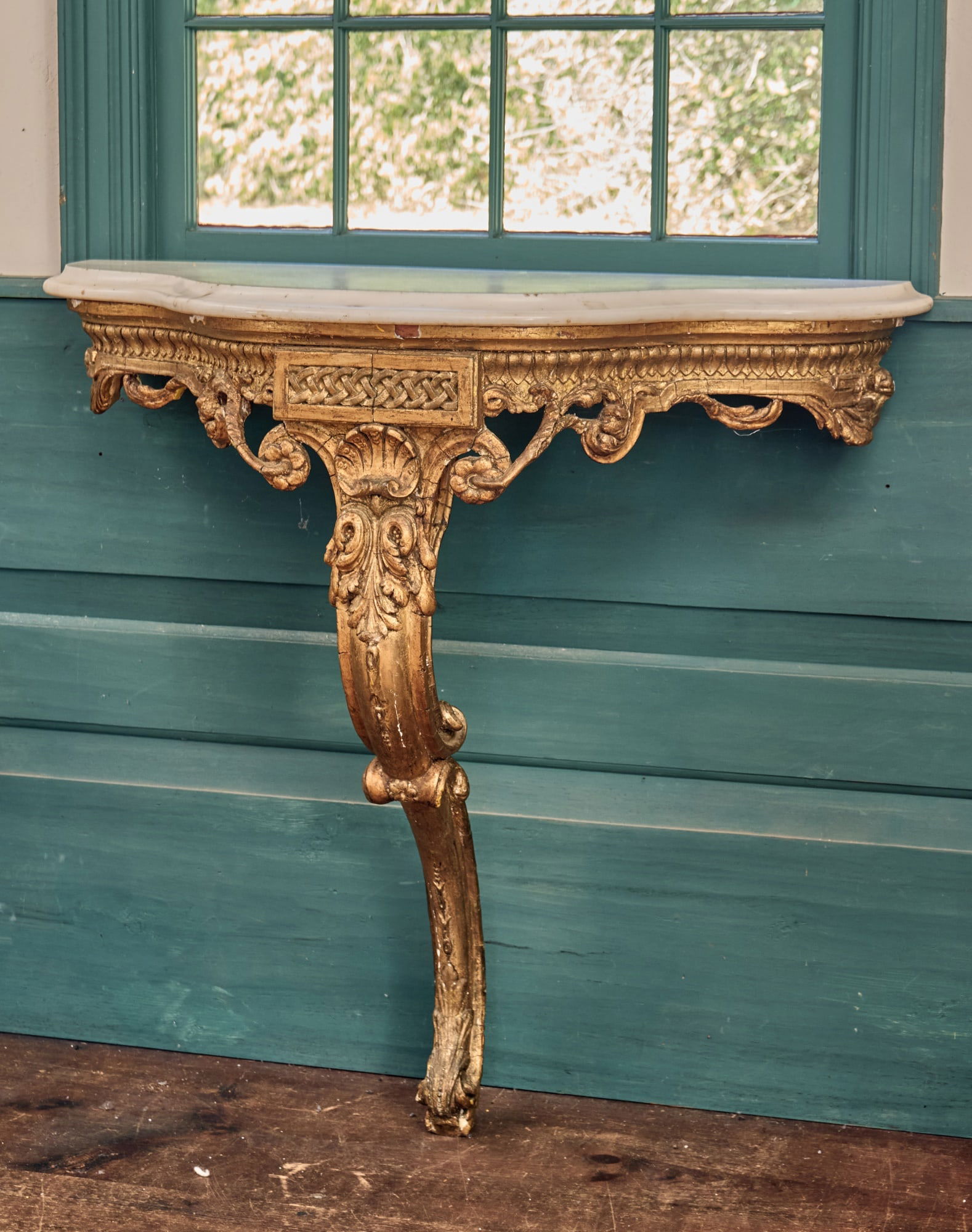 (18th c) CARVED & GILT MARBLE TOP CONSOLE TABLE: (18th c) Continental carved & gilt console table with shaped marble top, interesting faux woven carving, carved shell, other Rococo motifs. 35 3/4 x 37 1/2 x 15 1/4 inches. Condition: Some gilt loss.
