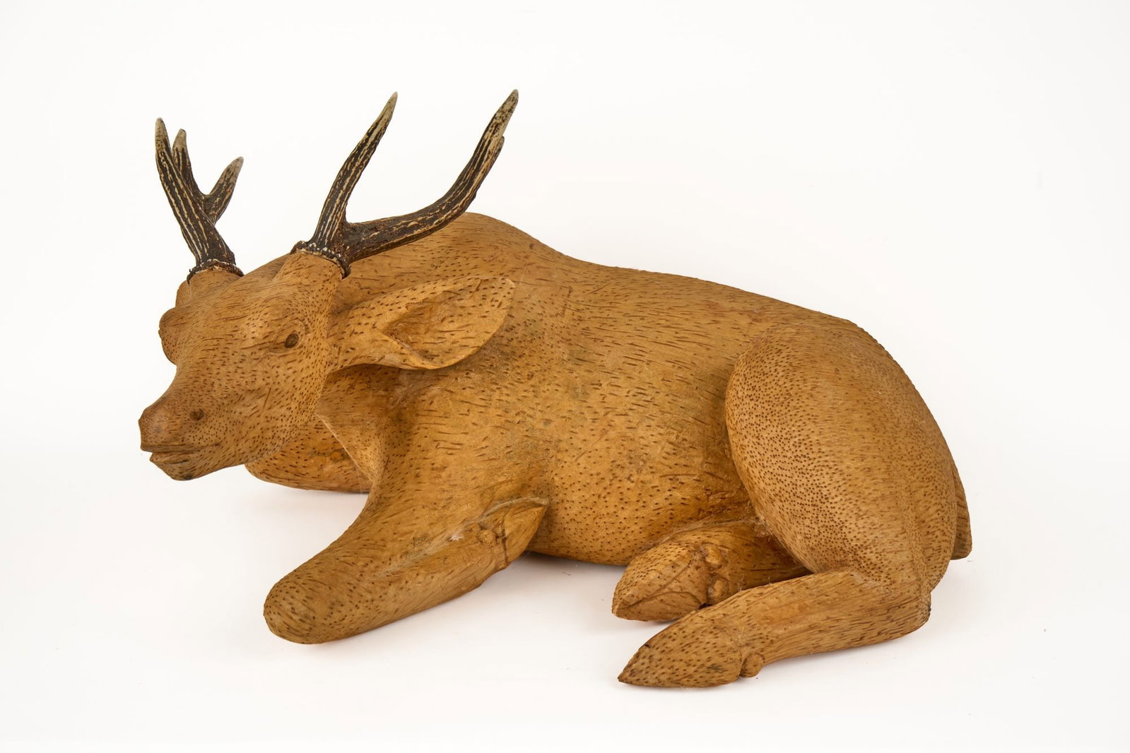 JAPANESE CARVED PALMWOOD DEER: Early to mid (20th c) figure of a resting deer with real antlers carved from palmwood. 15 x 23 x 15 inches. Condition: Some shrinkage cracks.