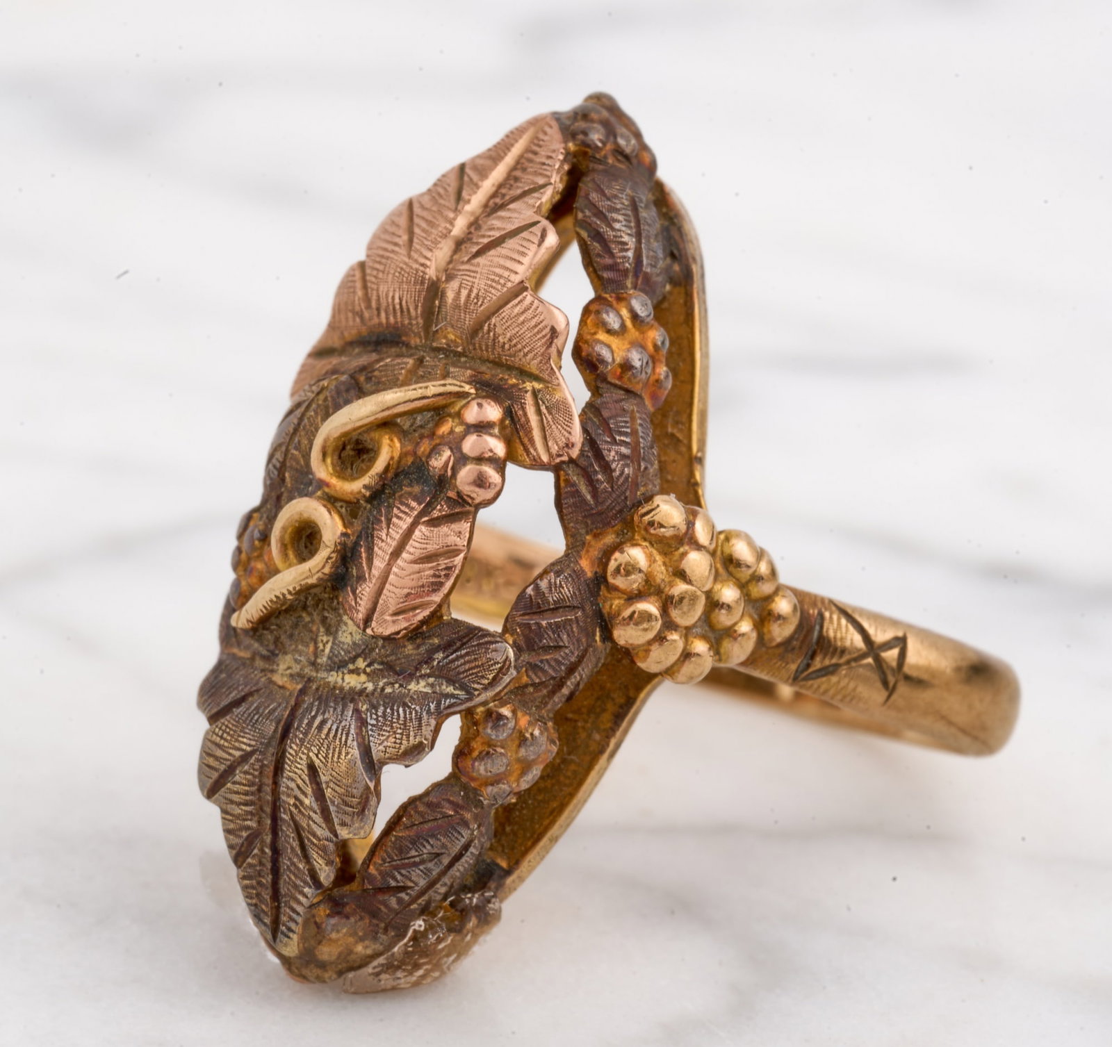 10k-12k GOLD BLACK HILLS RING: Pierced grape and leaf motif. size 4 1/2. 3 dwt. Condition: Shank out of round Temp No 8054