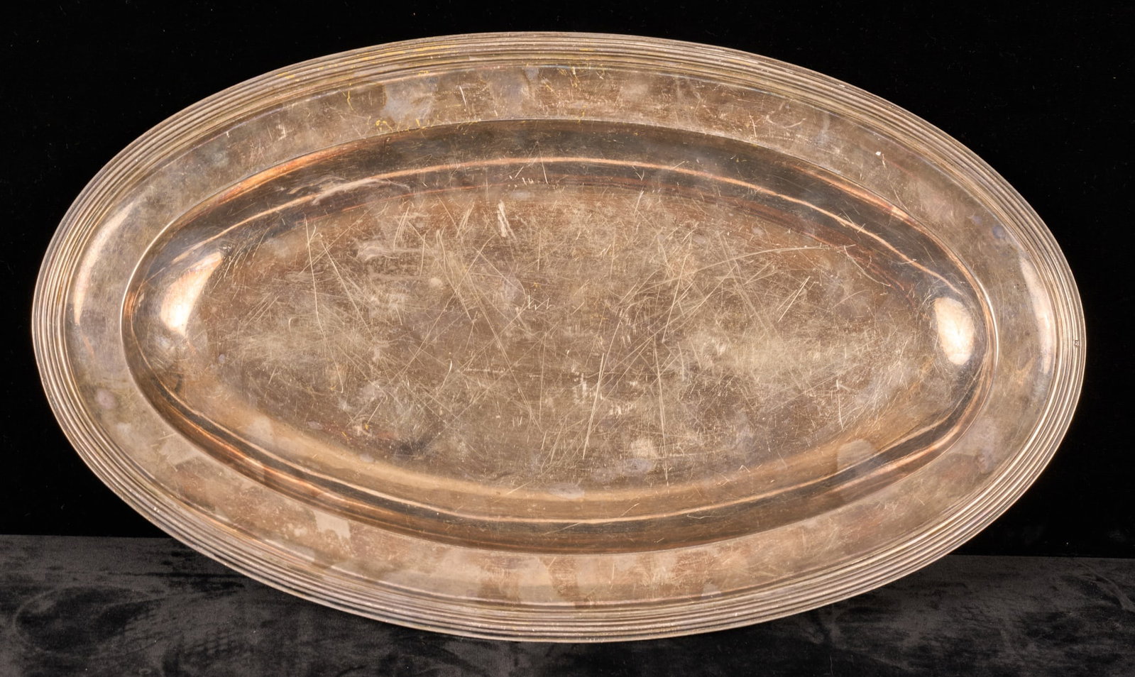 STERLING SILVER TRAY by PIERRE QUEILLE of FRANCE: Oval tray with reeded rim. 10 1/2 x 18 inches. Hallmarked with Minerva in clipped cornered cartouche. 34 troy ounces Condition: Scratches Temp No 7005s