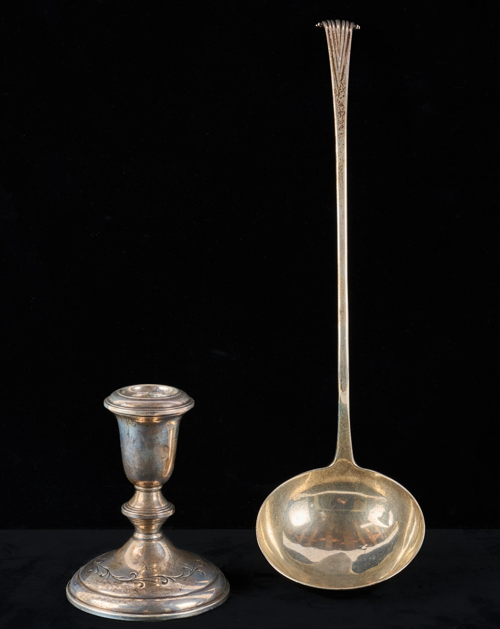 (19thc) BRITISH STERLING PUNCH LADLE & CANDLESTICK: 13 inches ladle with worn makers mark. 5.4 troy ounces. Together with a weighted candlestick by Towle. 5.4 troy ounces (not including weighted stick) Condition: Good Temp No 7095