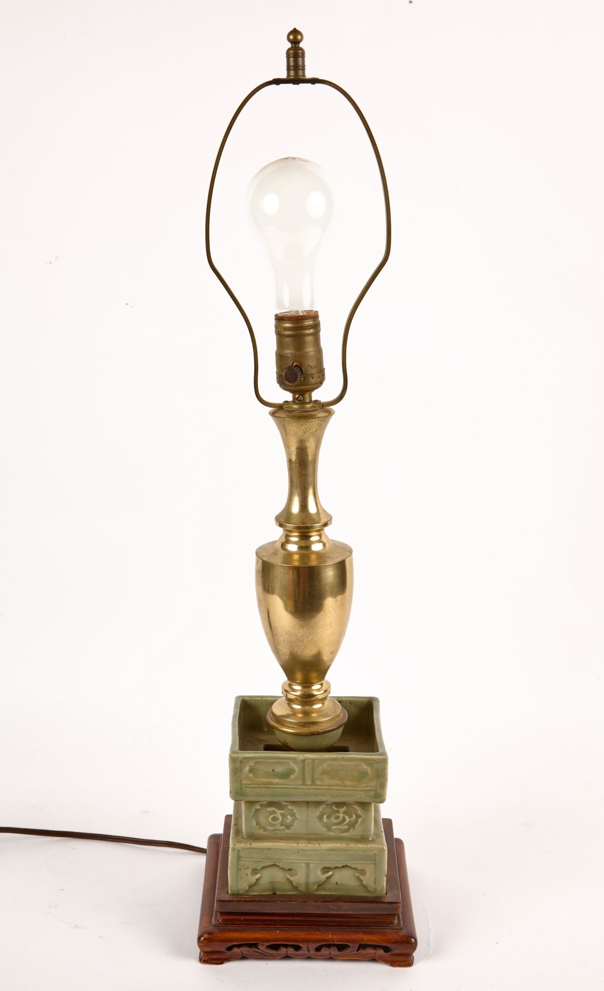 UNUSUAL (18th/19th c) CHINESE CELADON CANDLEHOLDER: Celadon glazed porcelain base with Chinese characters supporting a brass table lamp, on carved & pierced wooden stand. 26 inches.