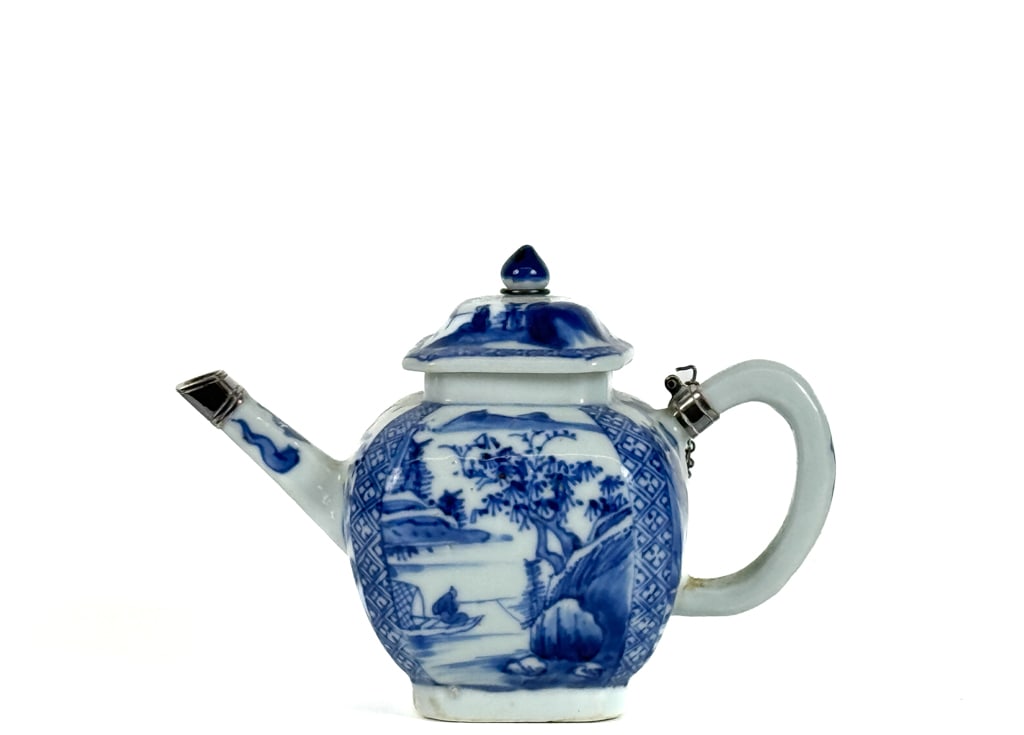 BLUE & WHITE CHINESE INDIVIDUAL TEAPOT: Decorated with mountain landscape. Capped with silver and lid linked via chain. 4 3/4 inches. Condition: Good.