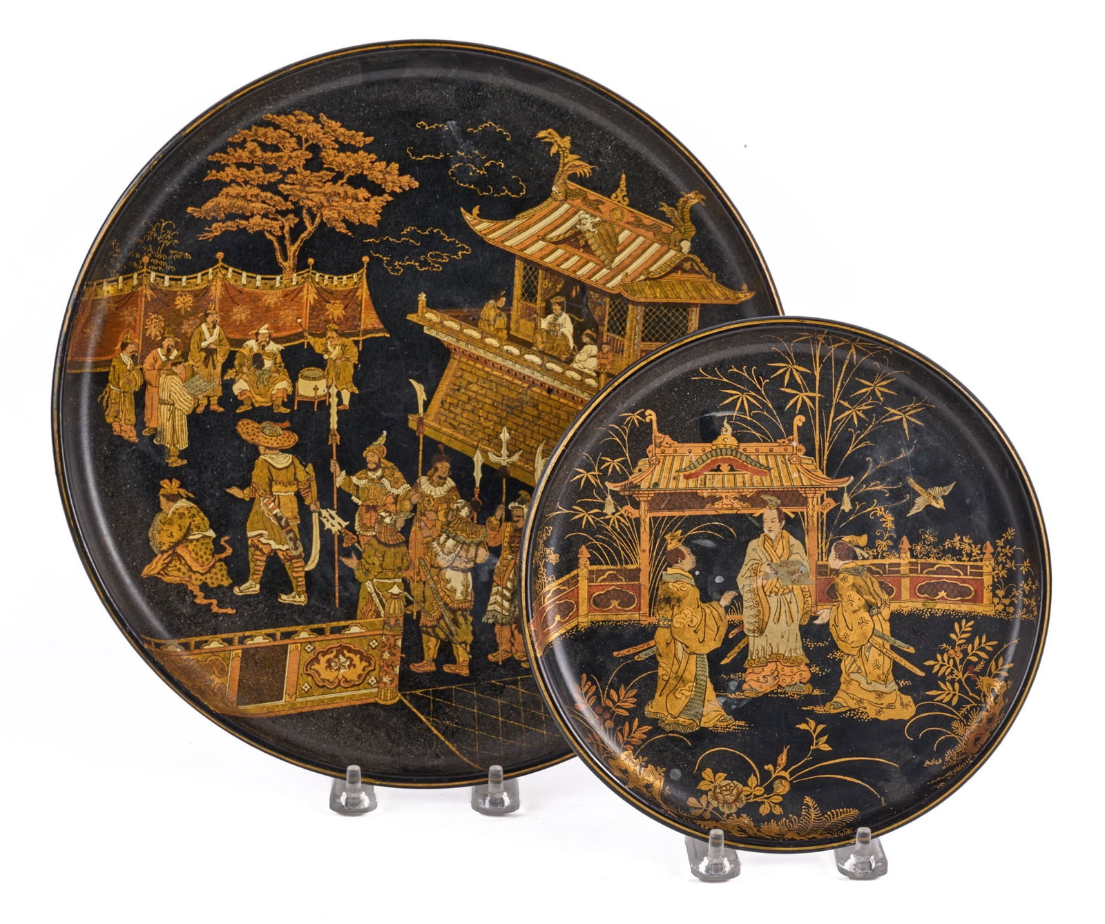 (2) CHINESE LACQUERED & GILT TRAYS: (2) Chinese lacquered plates gilt decorated with warriors. 12 inches. Condition: Mostly good, some minor wear. Temp No 7923