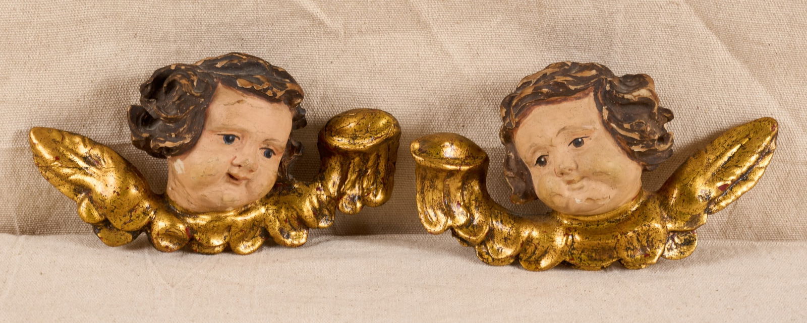 PAIR of (19th c) CARVED & GILT CHERUB HEADS: Carved & painted cherubs with gilt wings. 4 x 8 inches. Condition: Scattered losses. Temp No 8051
