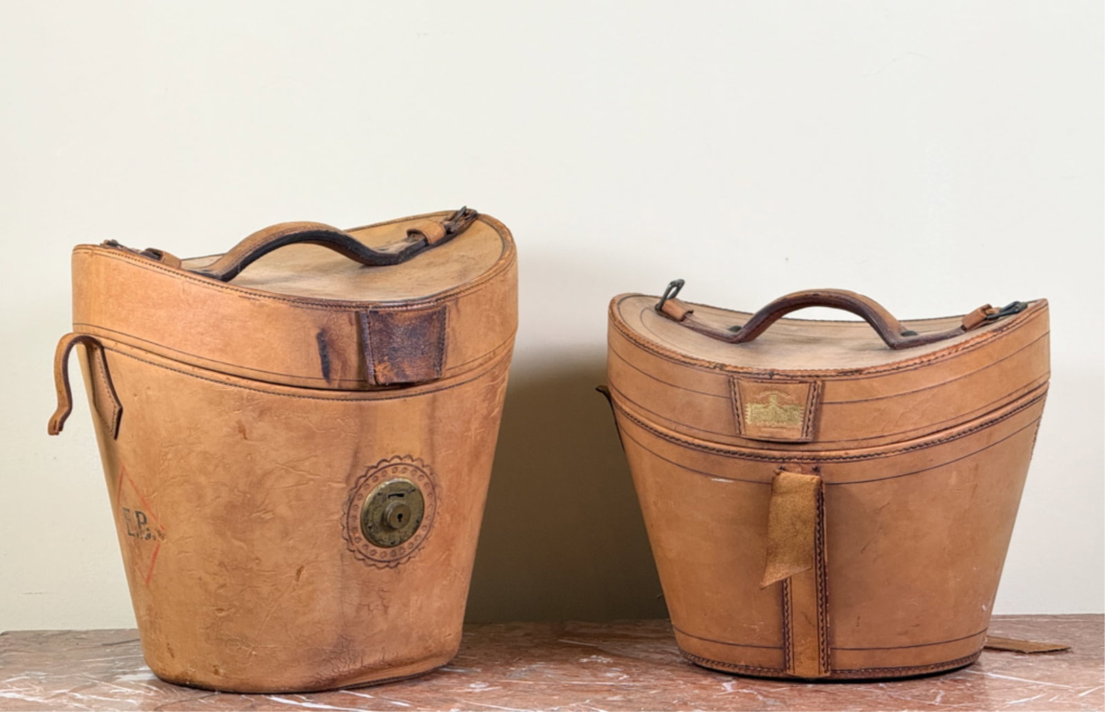 EARLY (19thc) HILL & MILLARD LEATHER HAT BOXES: With clean, fitted silk interiors. Tallest measures 14 1/2 x 14 inches.