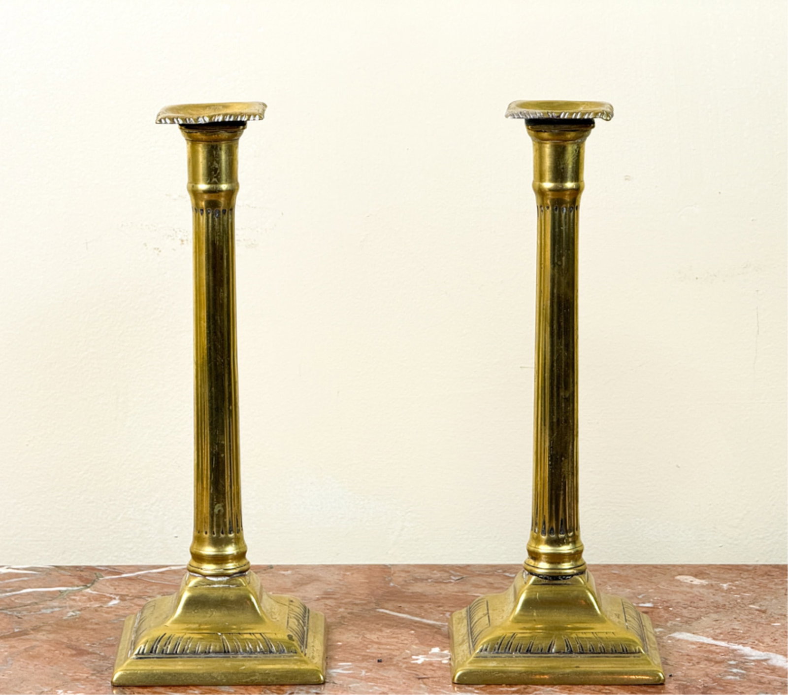 PAIR (18thc) NEOCLASSICAL BRASS CANDLESTICKS: Doric column candlesticks measuring 10 1/2 inches.