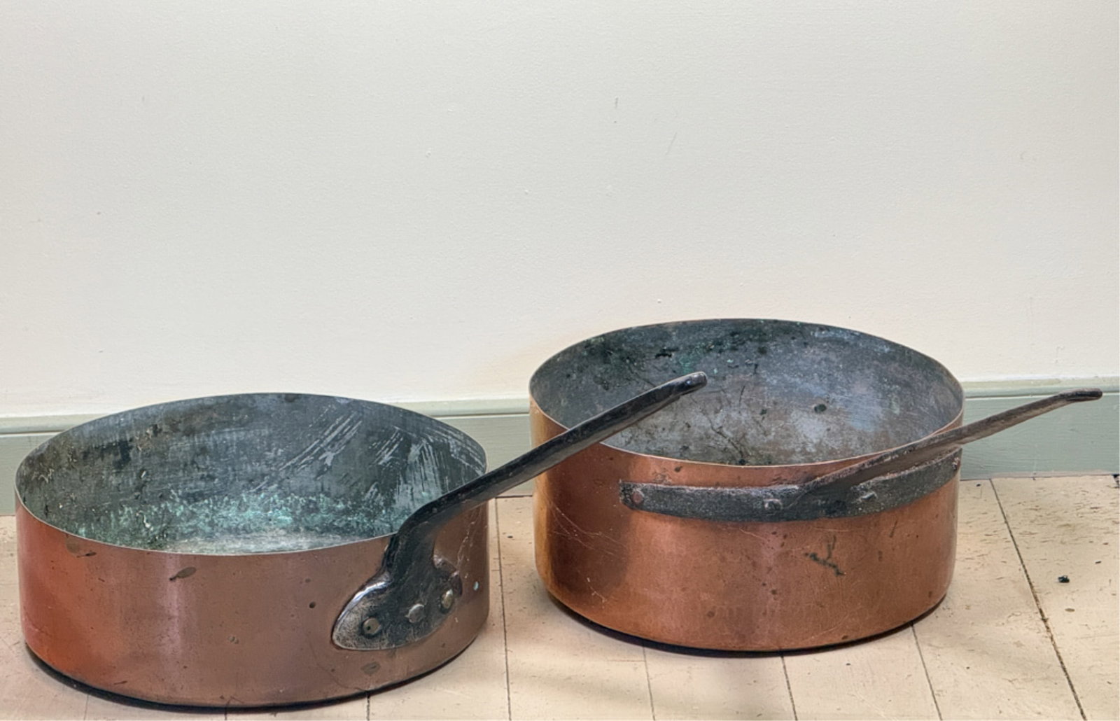 TWO (19thc) WROUGHT IRON & COPPER POTS: Hand hammered and dovetailed construction. Longest measures 35 1/2 inches.