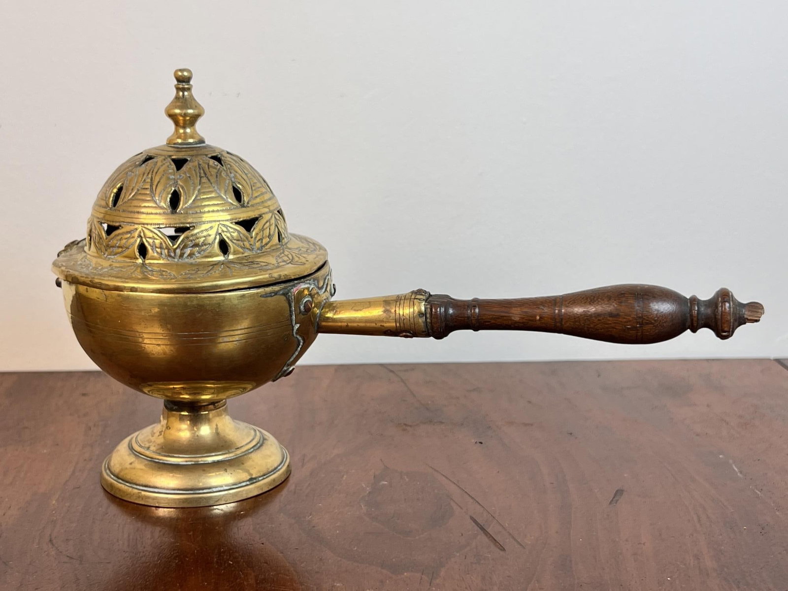 (18th c) PIERCED BRASS INCENSE BURNER: With chased decoration and turned wooden handle. 10" total length