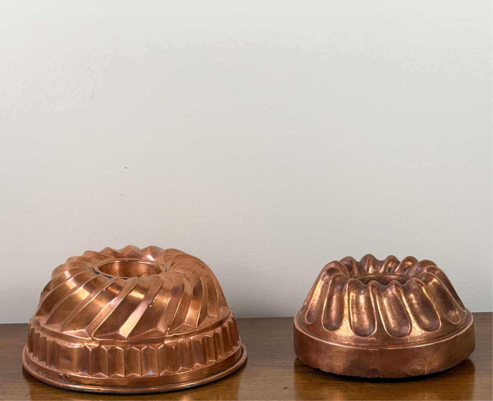 (2) FRENCH COPPER BUNDT CAKE MOLDS: Largest measures 10 inches.