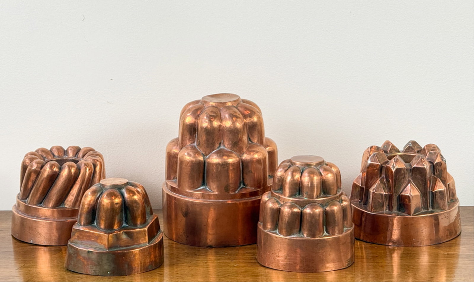 GROUP (5) COPPER CAKE/PUDDING MOLDS: Tallest measures 7 inches.