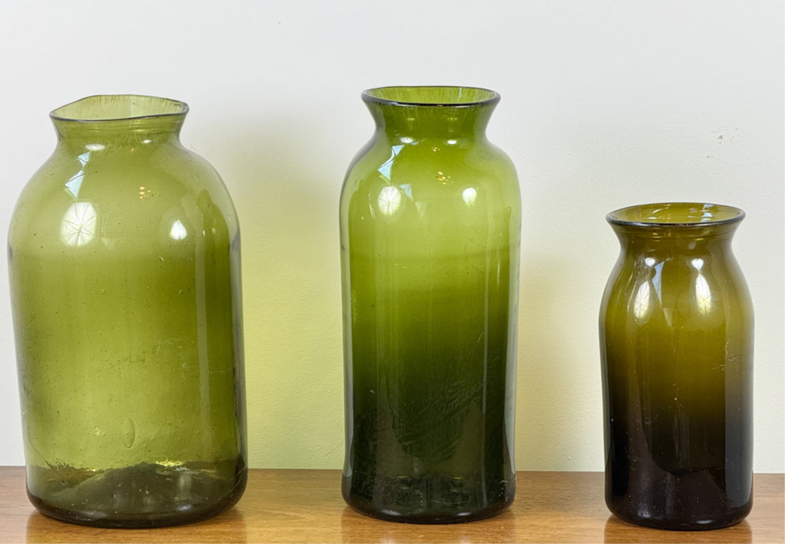 (3) HAND BLOWN (19thc) CORNICHON JARS: In olive green. Tallest measures 15 inches.