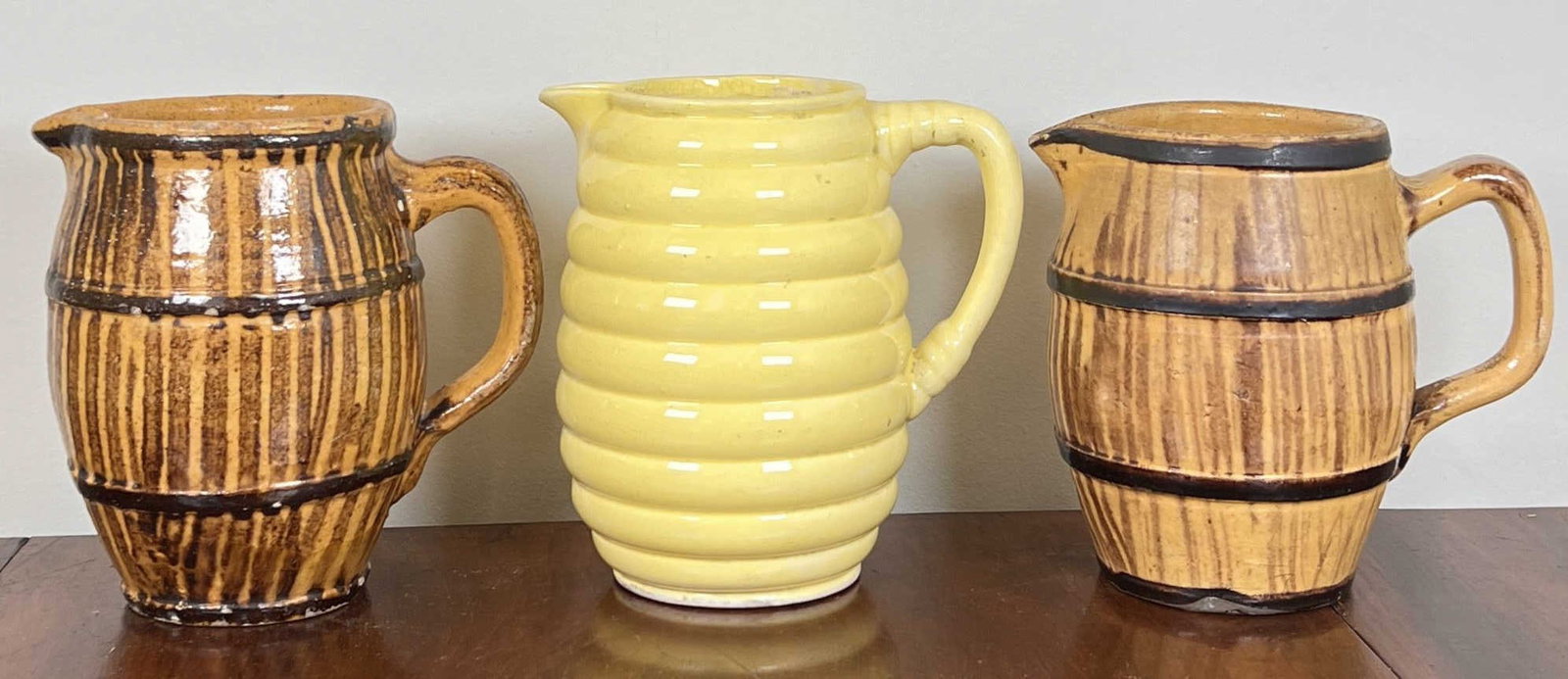 (3) BARREL FORM POTTERY PITCHERS: Along with a bee hive design example. Tallest 6 1/2"