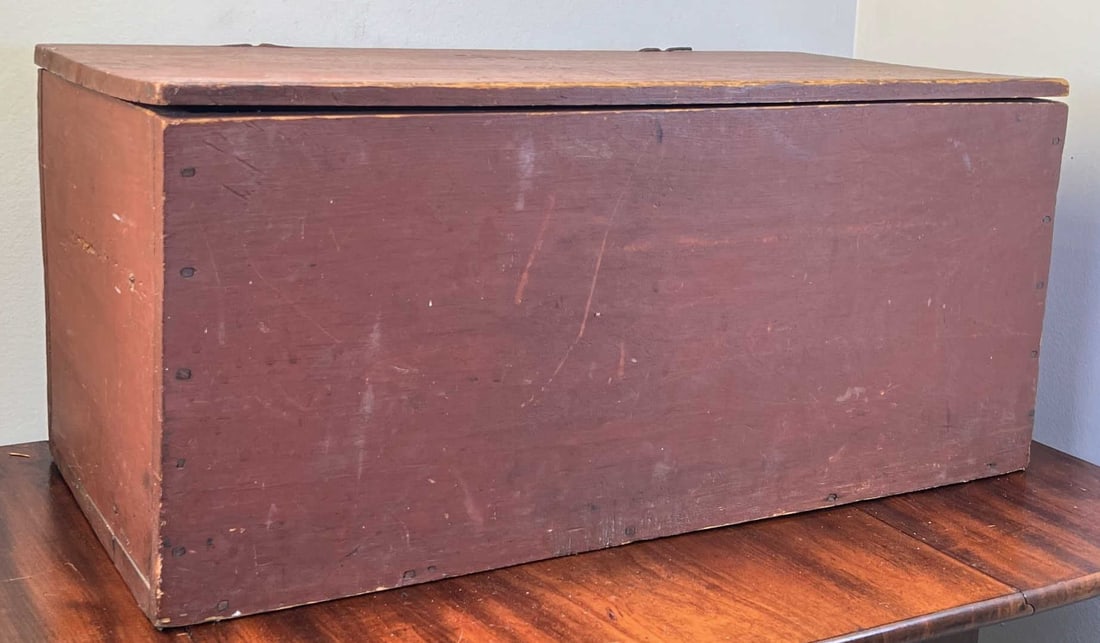 (19th c) DIMINUTIVE SIX BOARD CHEST: In old red paint with snipe hinges. 10 3/4" x 23 3/4" x 11 3/8"