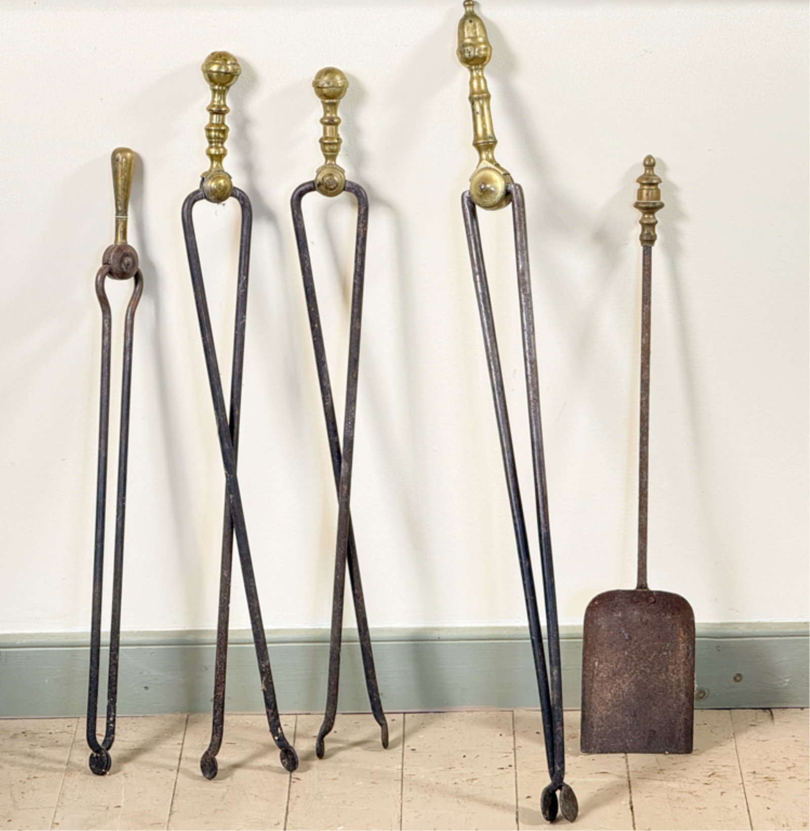 FIVE (19thc) BRASS & IRON FIREPLACE TOOLS: Pair Sheraton tongs, acorn finial, etc. Longest measures 32 inches.