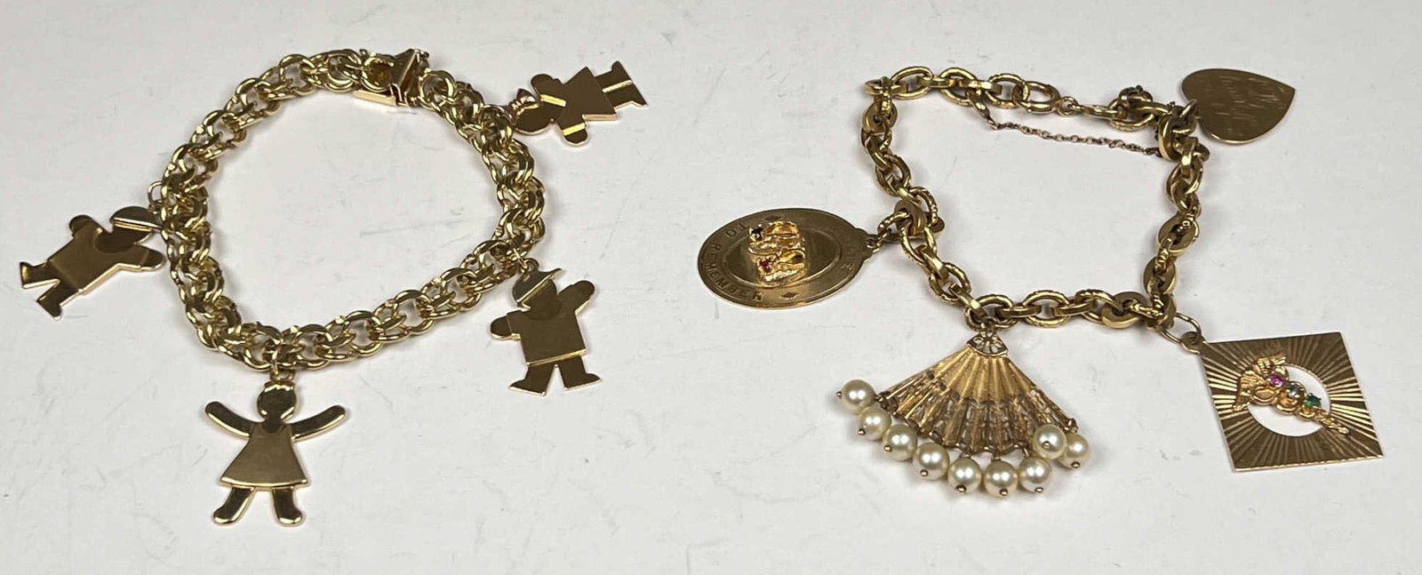 (2) 14K GOLD CHARM BRACELETS: Both marked 14k. All charms marked or test 14k. 48.4 grams total weight
