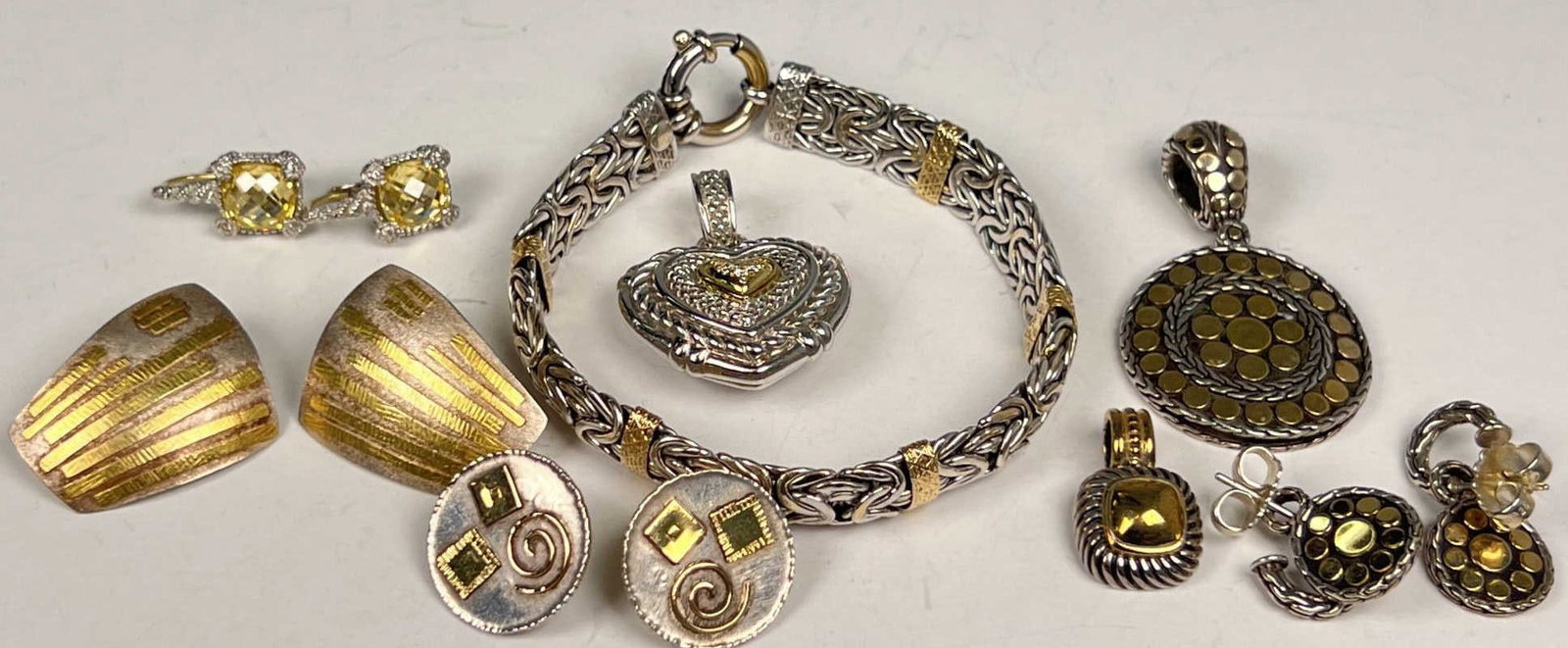 GROUPING OF GOLD AND STERLING SILVER JEWELRY: All pieces are a combination of sterling silver and 14k-22k gold. 89.3 grams overall. One piece David Yurman