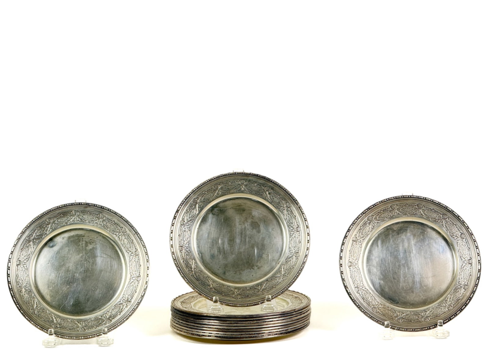 (12) R WALLACE & SONS STERLING SILVER BREAD PLATES: With hand engraved floral border. Each Retains individual velvet pouches from The Frank Herschede Company of Cincinnati. 6 inches. 27.91 ozt.