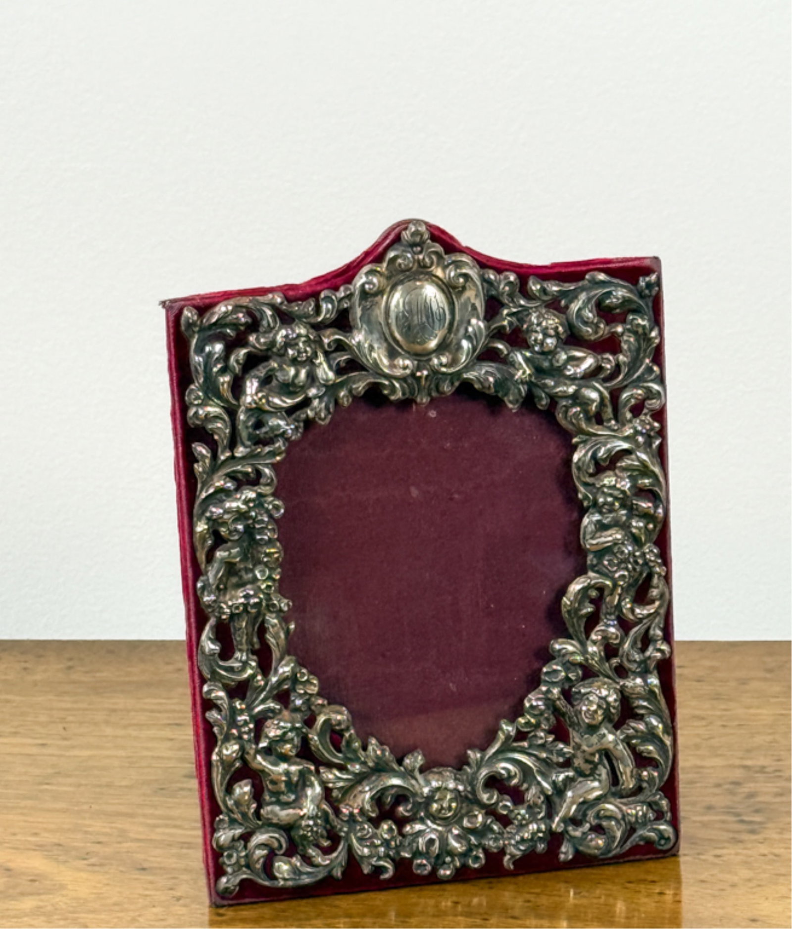 BLACK STARR & FROST STERLING SILVER PICTURE FRAME: Repousse frame with putti and cartouche. 7 1/2 x 5 1/2 inches.